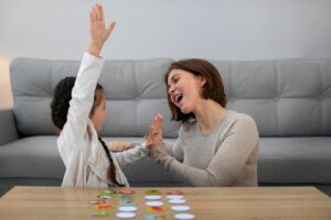 A woman and child engage in a playful game