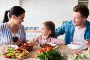 A family gathering around a dining table filled with various dishes