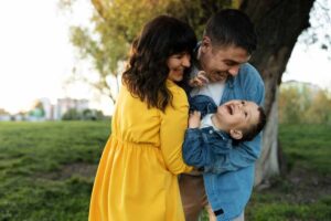 A joyful family embraces in a park during golden hour