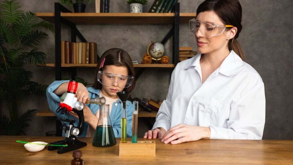 Young girl and woman conducting science experiments with microscope and test tubes in a home laboratory setting.