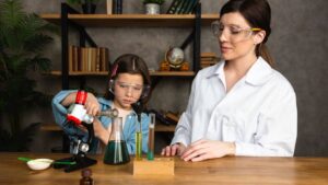Young girl and woman conducting science experiments with microscope and test tubes in a home laboratory setting.